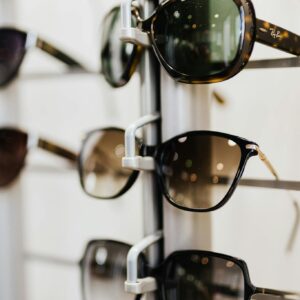 A selection of stylish sunglasses displayed on a retail stand. Ideal for eyewear fashion enthusiasts.